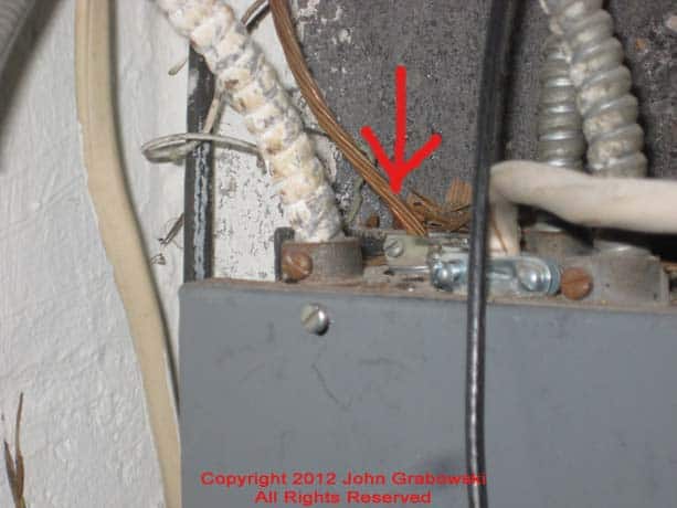 A close shot of the grounding electrode conductor as it enters the main electrical panel. 