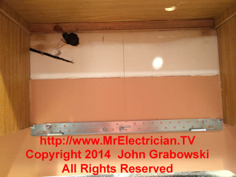 Microwave oven wall mounted bracket and holes drilled in kitchen cabinet