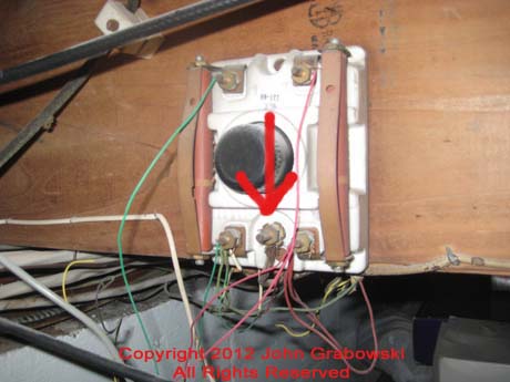  The arrow indicates the existing grounding terminal on the original telephone demarcation point.