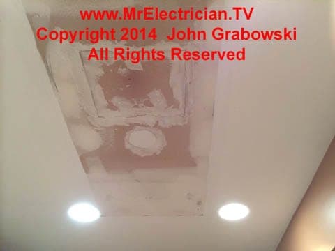 A completed rough patch of ceiling holes that were made to facilitate the installation of recessed lights in a condominium kitchen