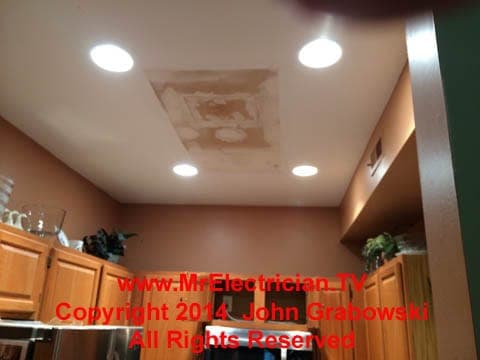 Completed recessed light installation in a condo kitchen