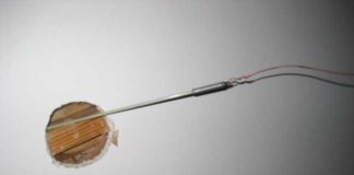 A fiberglass fish rod is used here to fish a Type NM-B cable through a ceiling.