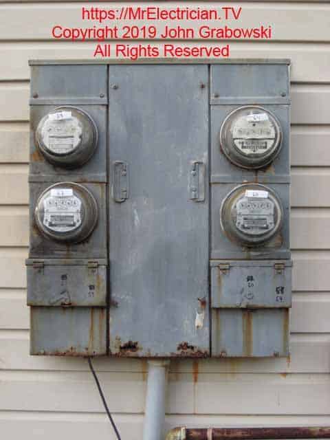 An old 4 gang electrical meter socket box