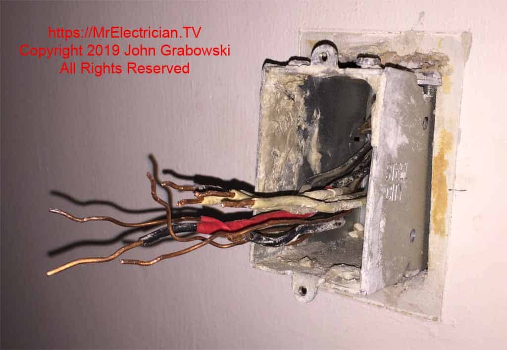 With the nails and cable clamps removed and the electrical splices taken apart, the electrical box in the wall is free to be removed