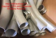 Photo of four inch PVC and EMT electrical conduit factory made elbows and EMT compression couplings