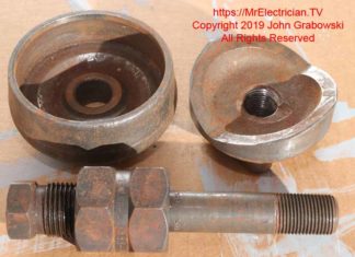 Two and a half inch trade size knockout punch and draw stud for punching a hole for two and half inch electrical conduit.