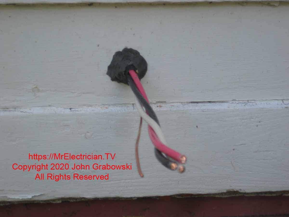 6/3 type NM cable pulled through the side of the house with duct seal in the hole and the outer jacket insulation removed so that the single conductors are exposed