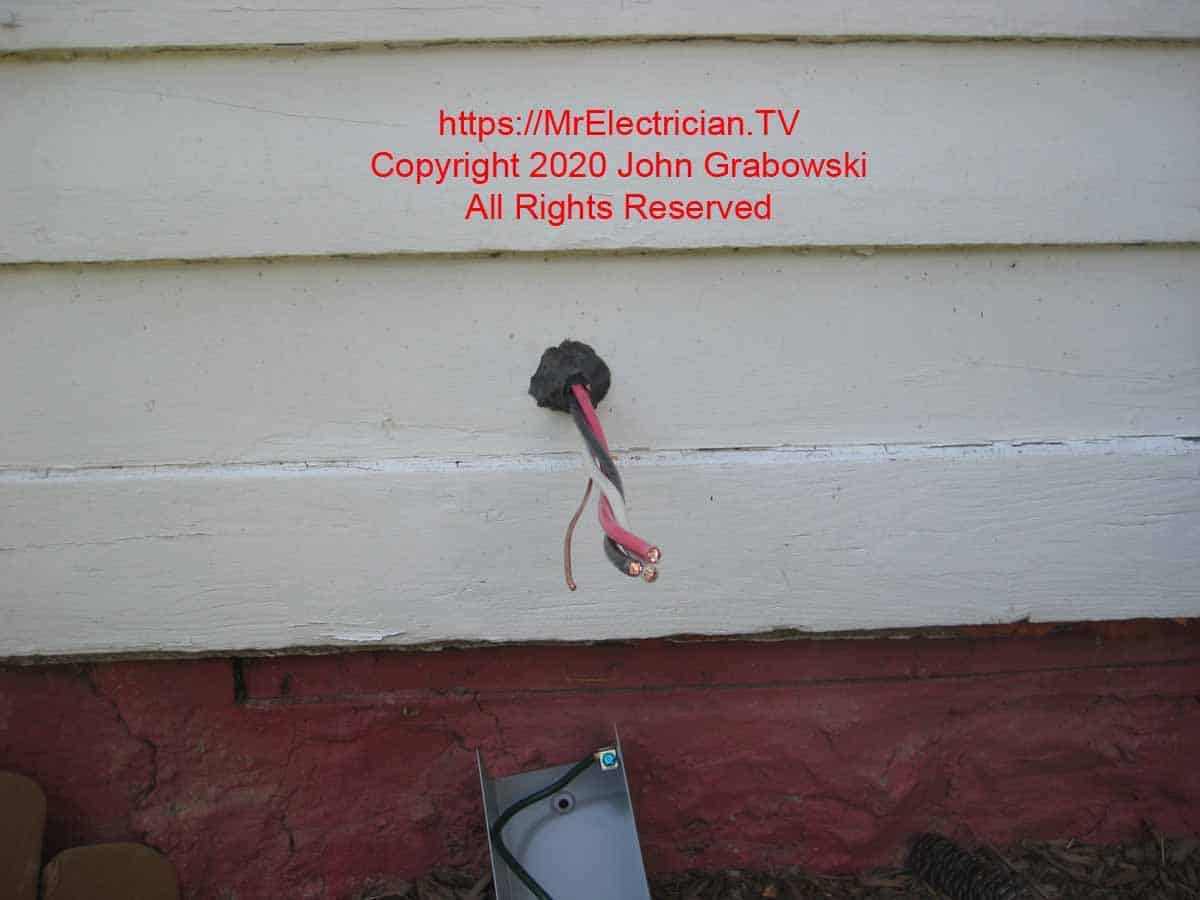 6/3 type NM cable pulled through the side of the house with duct seal in the hole and the outer jacket insulation removed so that the single conductors are exposed
