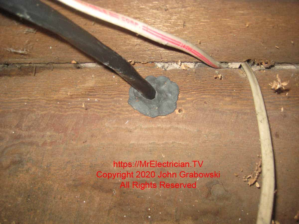 6/3 type NM cable coming through the rim joist with duct seal in the hole to prevent air from coming in