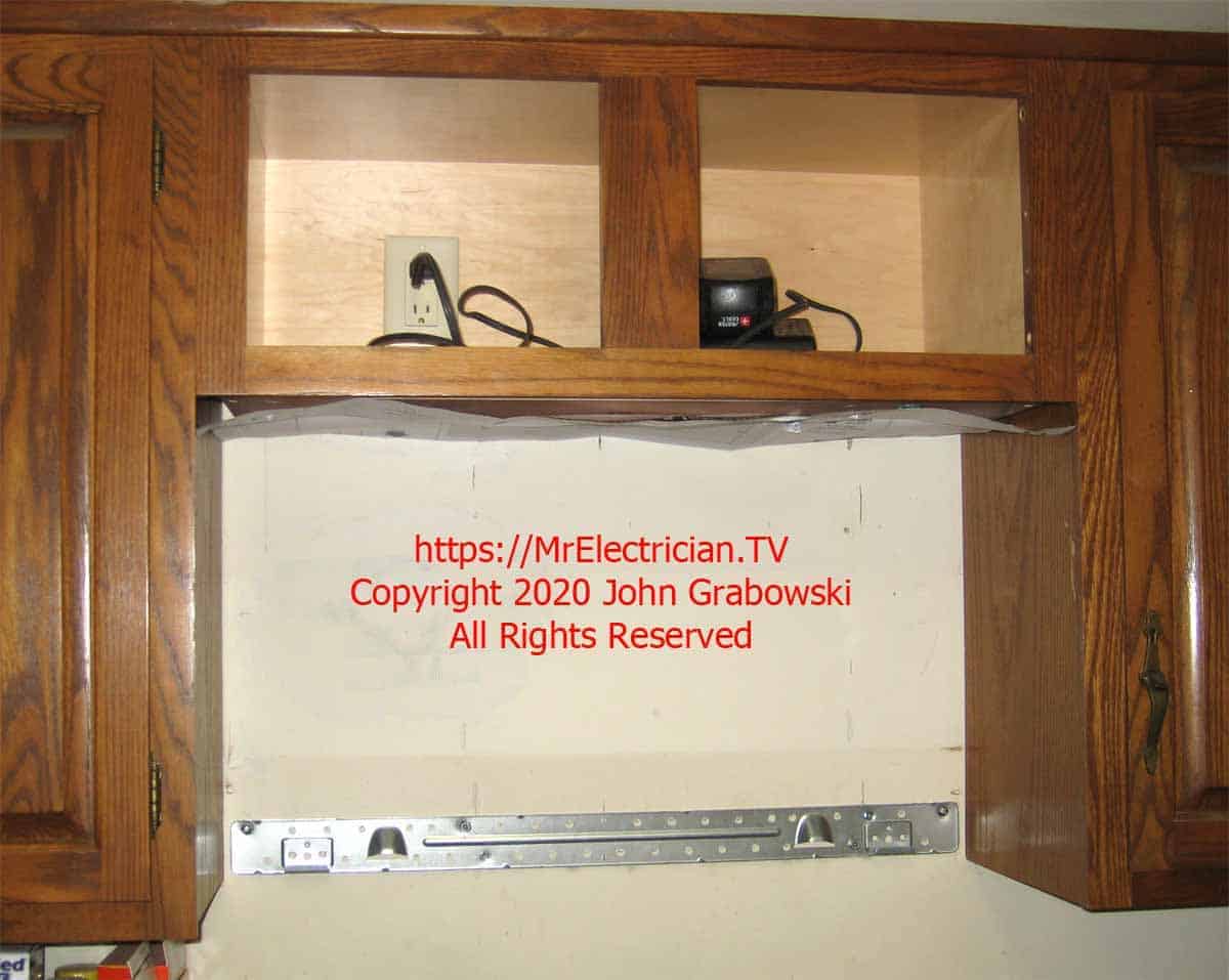 Completed electrical outlet inside of the cabinet and the wall bracket for the microwave oven