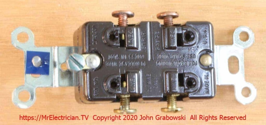Rear view of an old 4-way with copper screw terminals on one side and brass screw terminals on the other side.
