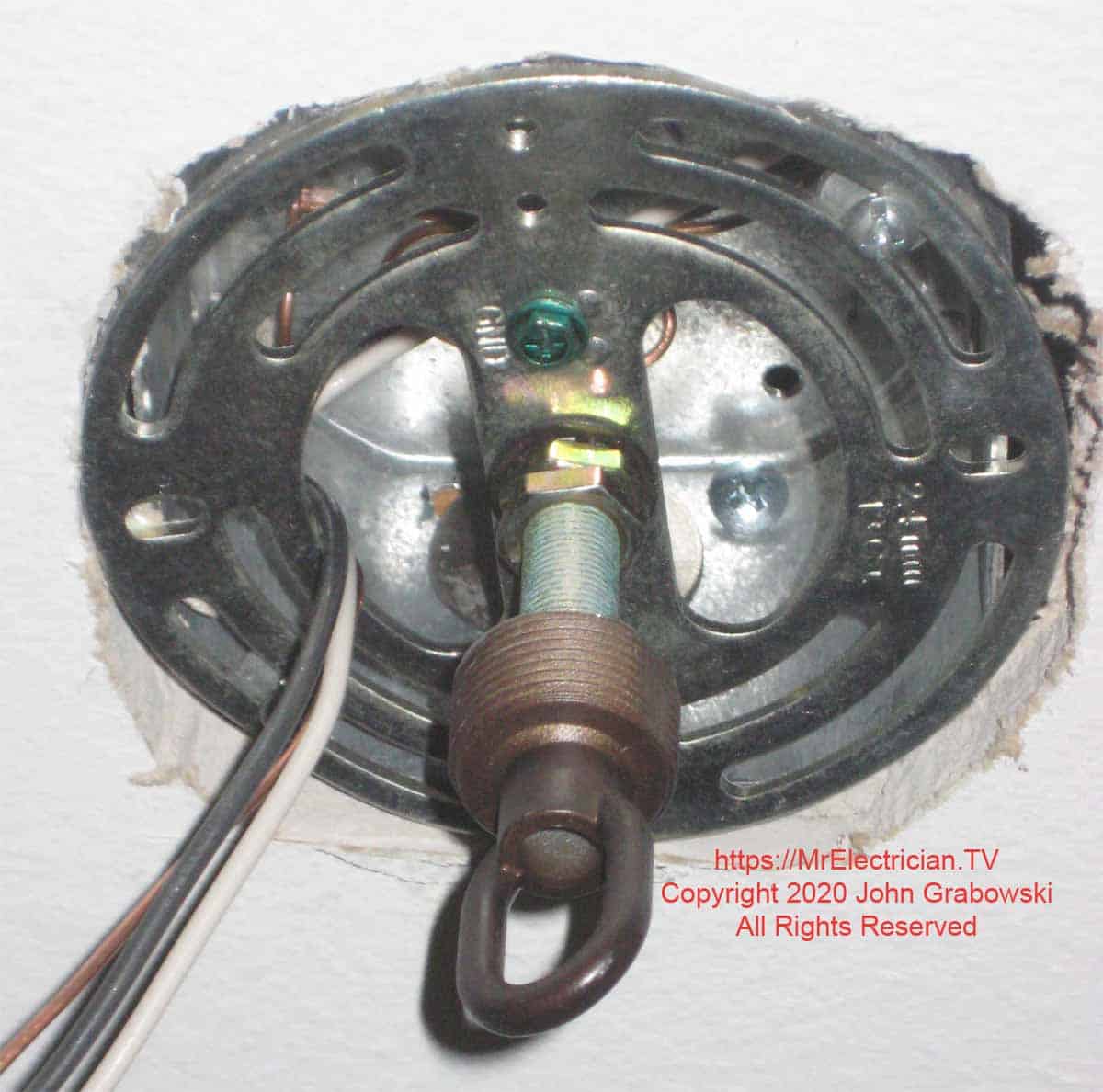 The light fixture hook and bracket are attached to the deep octagon electrical box in the ceiling