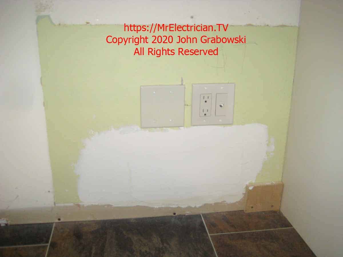 Patched hole and covered junction box, and outlet with phone jack under the counter top