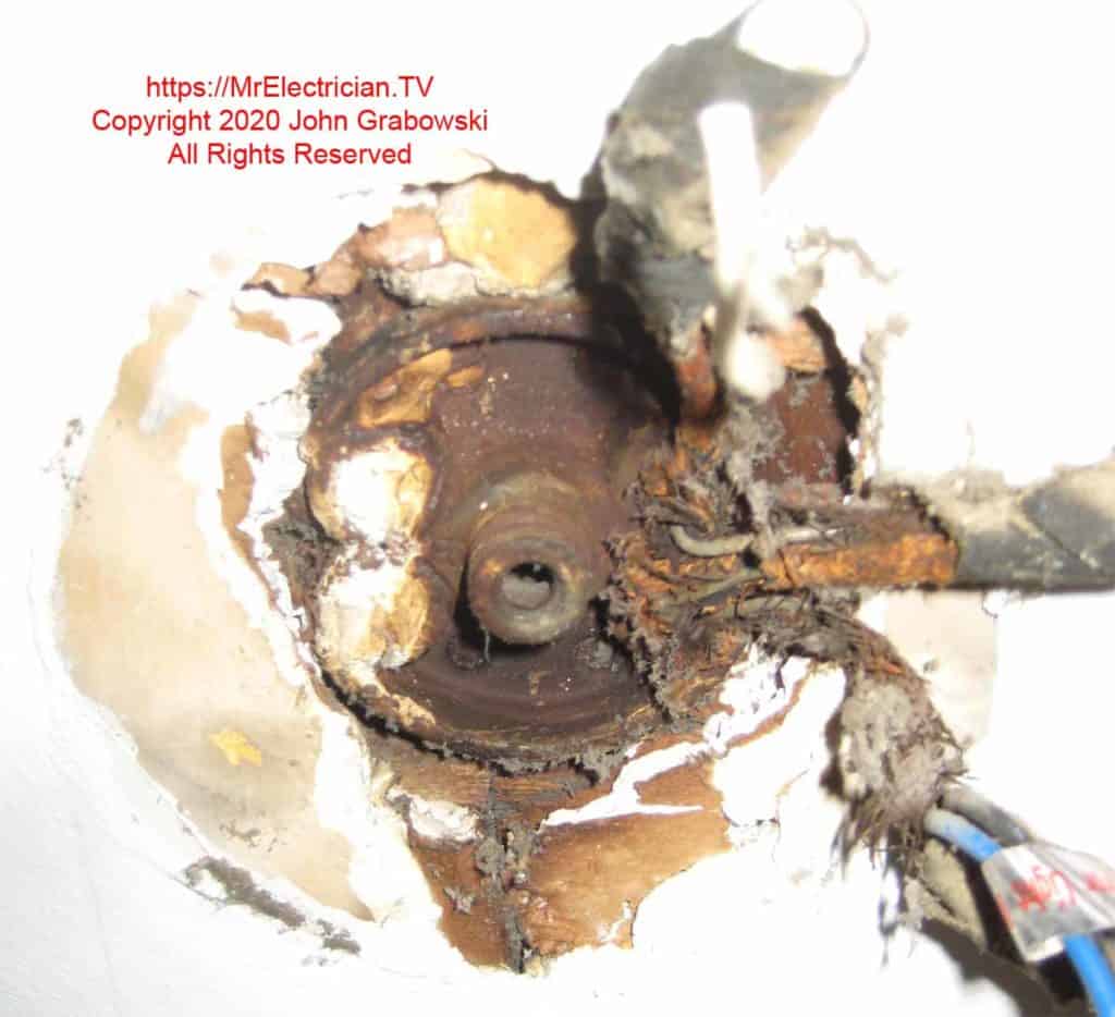 Old style pancake electrical box embedded in ceiling with broken wires Old style pancake electrical box embedded in ceiling with broken wires