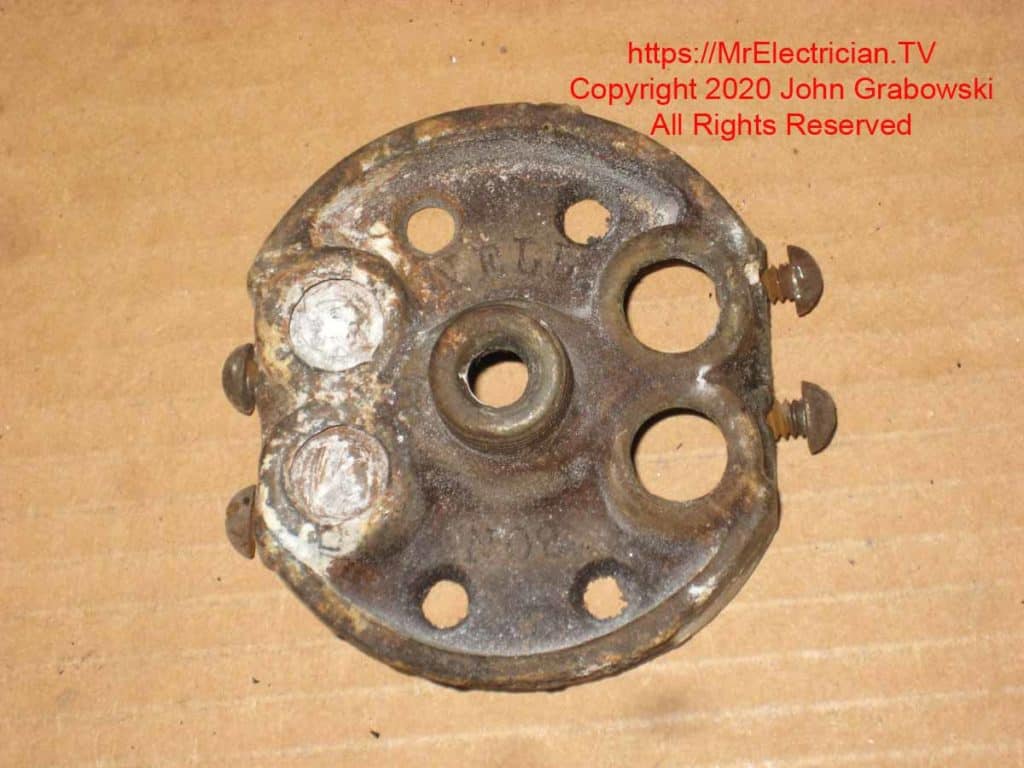 The front side of the old pancake electrical box after it has been removed from the ceiling. The front side of the old pancake electrical box after it has been removed from the ceiling