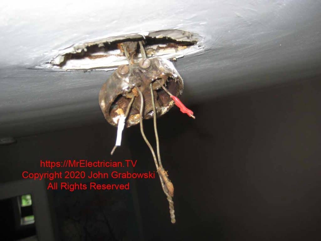 Very old pancake box hanging by bare electrical wires Very old pancake box hanging by bare electrical wires