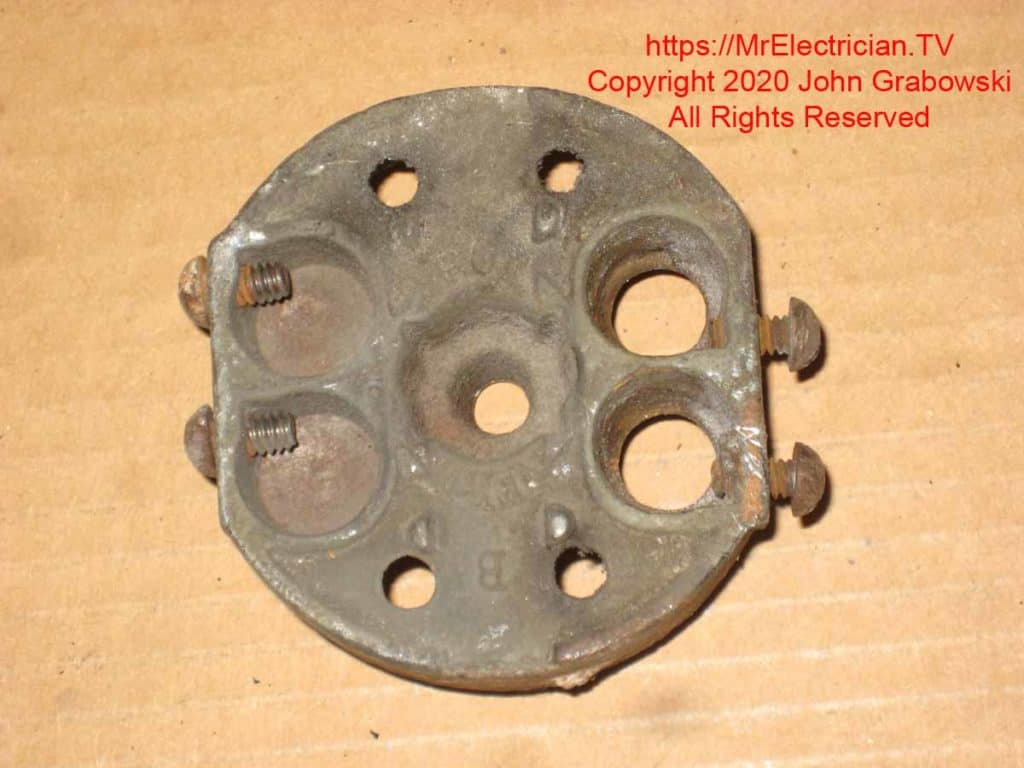 The back side of old pancake electrical box after it has been removed from the ceiling The back side of old pancake electrical box after it has been removed from the ceiling