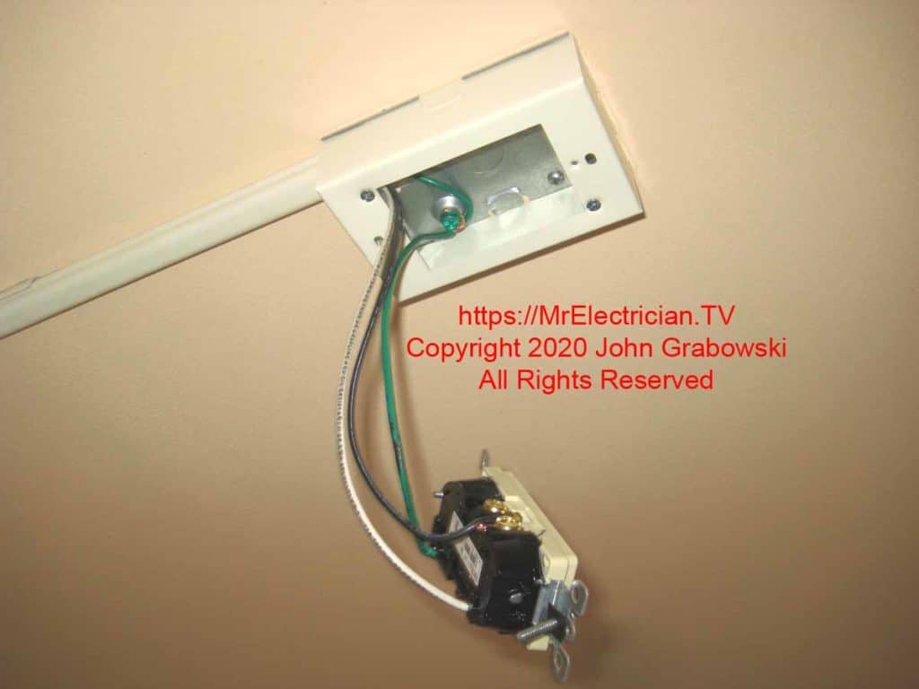 Ceiling mounted Wiremold box with wires and outlet hanging down