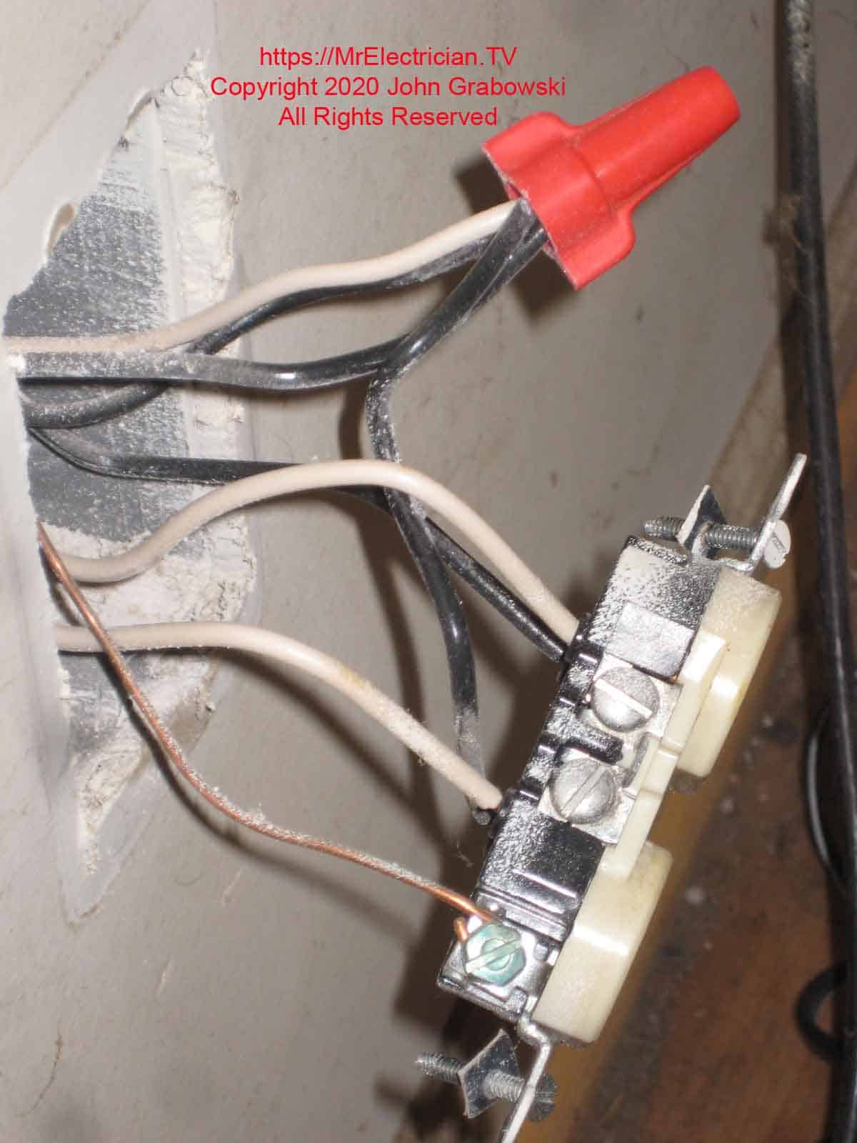 A half-switched outlet with a white wire LINE feed to the wall switch.