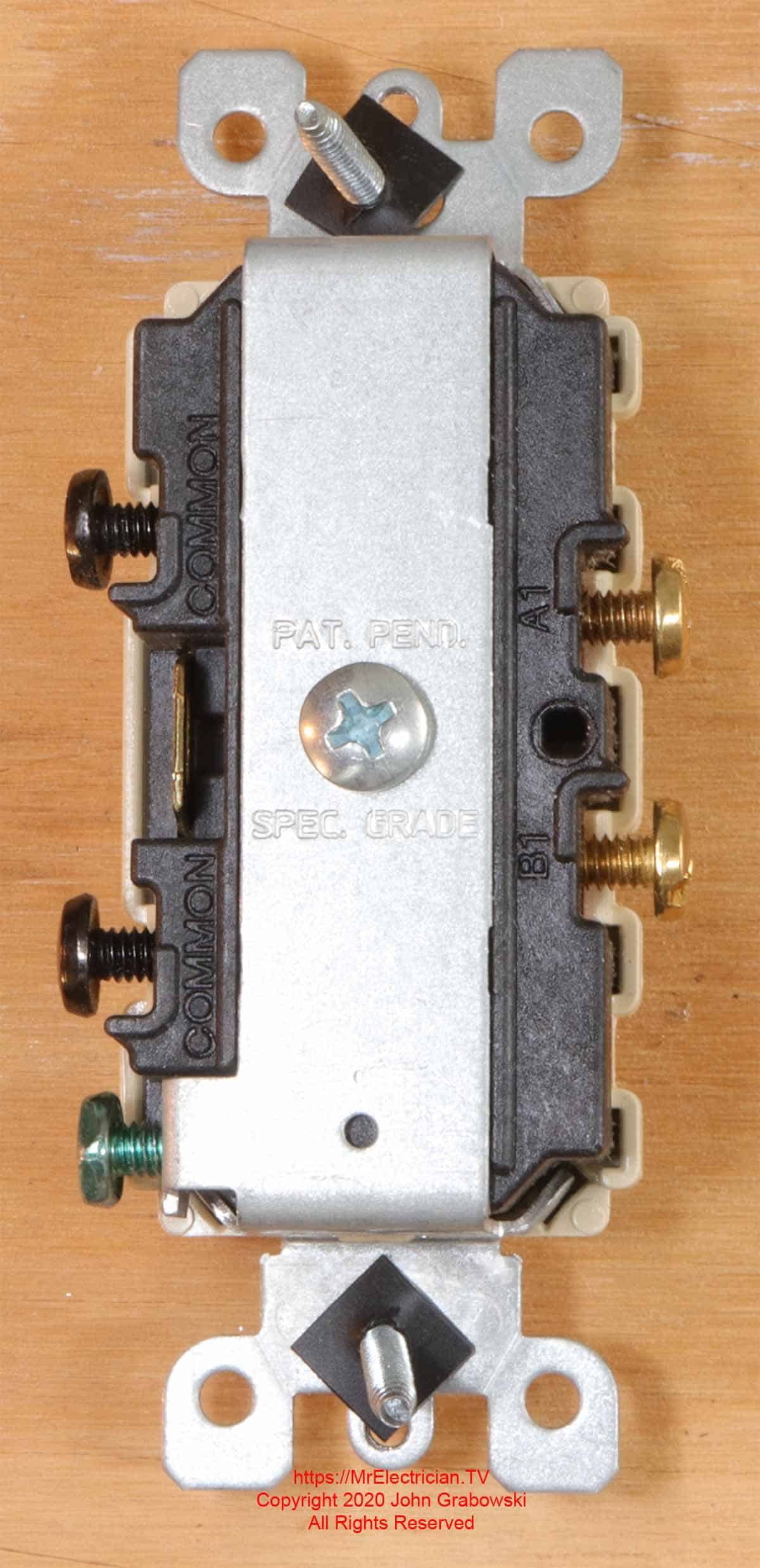 Depicted is the wiring terminals on the rear view of a combination switch device with two single pole switches