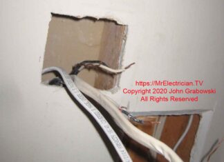 Hole in wall cut for a new two gang electrical box for the new bathroom fan switch