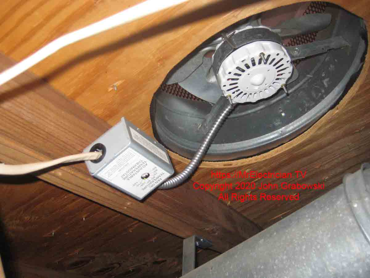 An attic fan with a new thermostat installed