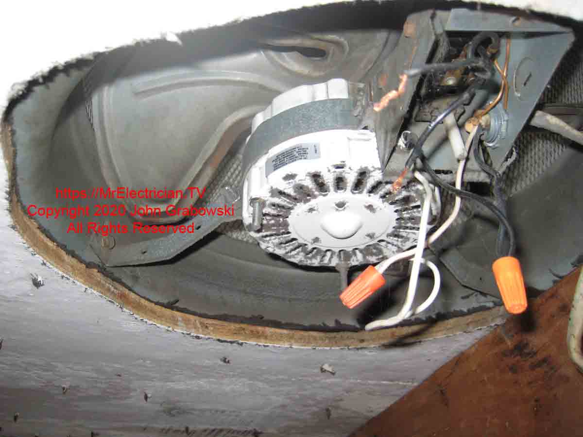 An attic fan with an accumulation of dust