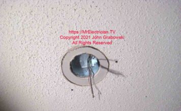 Drywall ring loosely fitted for size around a ceiling fan box