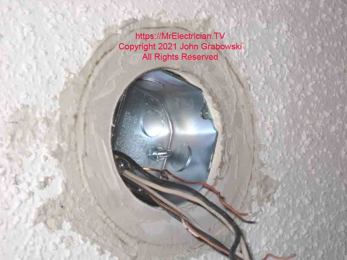 A drywall ring mudded in a recessed light hole with a fan rated ceiling electrical box