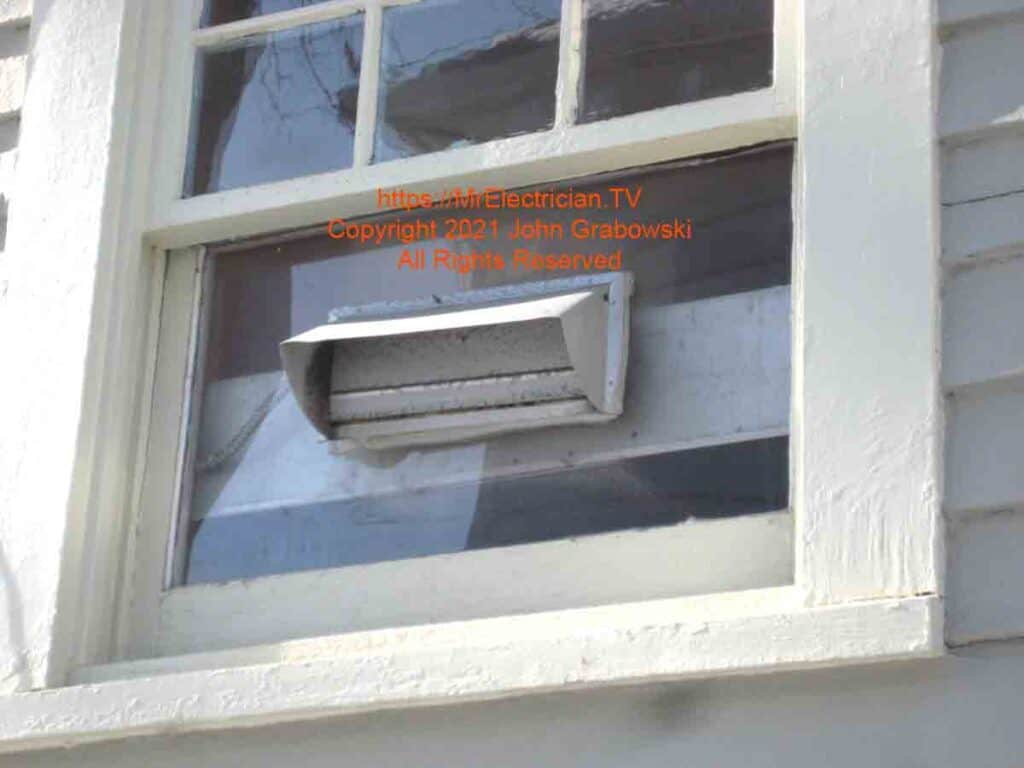 This photo depicts a kitchen hood exhaust vent that was cut through a window.