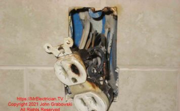 A burned electrical outlet in a kitchen backsplash