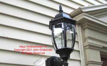 Outdoor light fixture mounted with an indoor electrical box, duct tape, and caulk