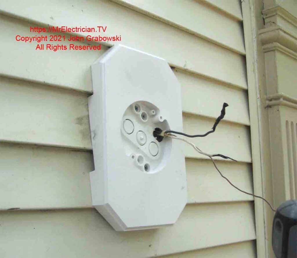 A siding box is used to mount a light fixture on vinyl siding outside.