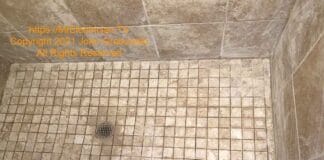 Existing shower floor with some of the grout removed