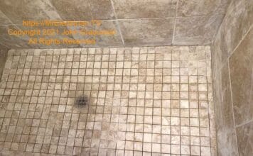 Existing shower floor with some of the grout removed