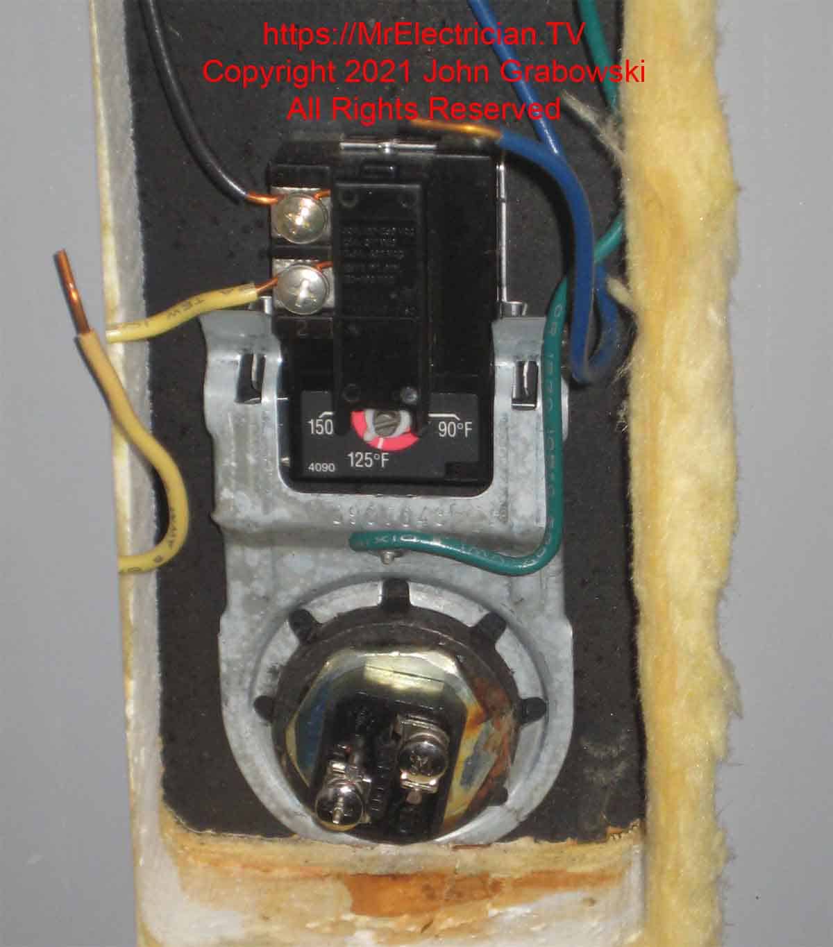 An electric water heater lower thermostat and heating element