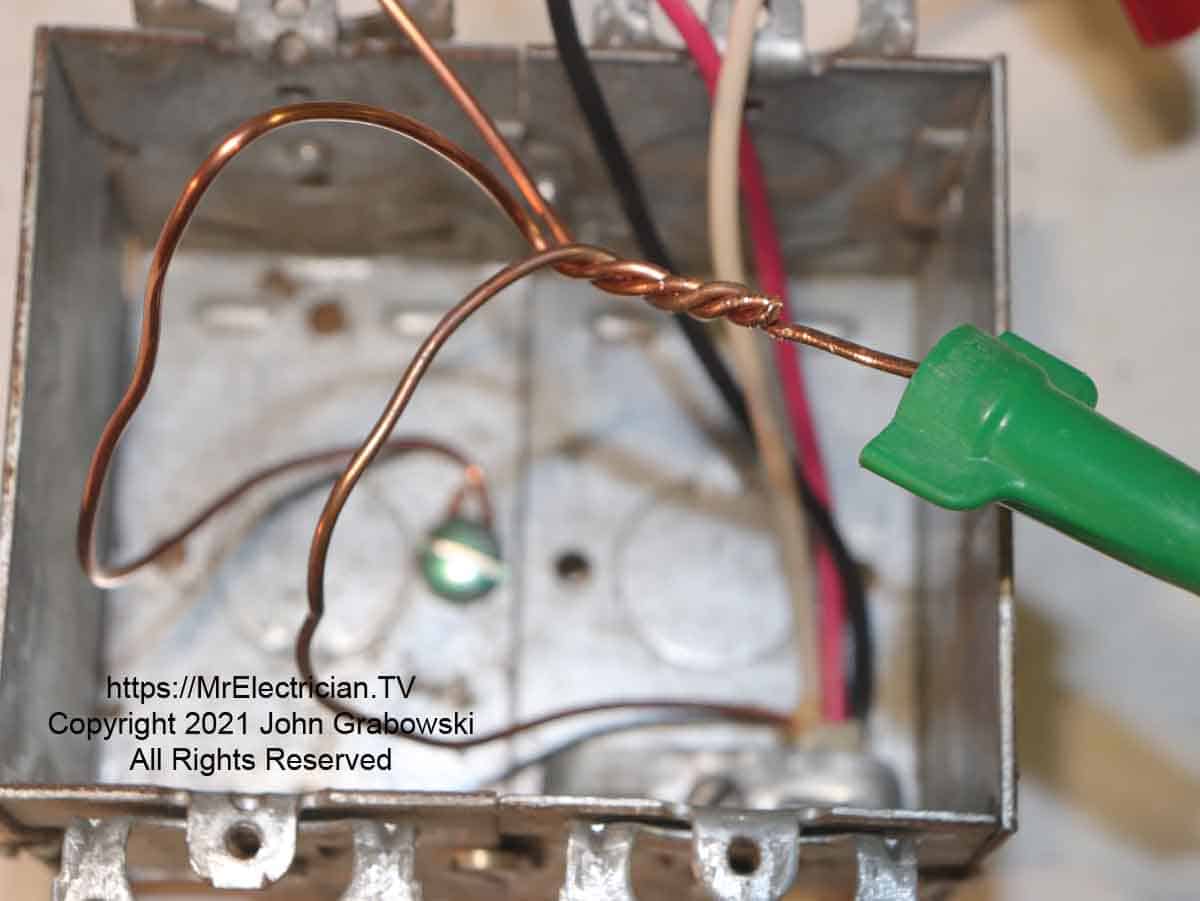 Ground wires twisted tightly together before the green wire connector is screwed on