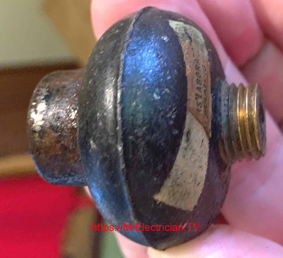 A photo of an electrical insulator that was removed when electric wall sconces were taken down in a 1910 house.