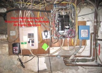 Two old basement electrical sub-panels, one of which is fed from the other