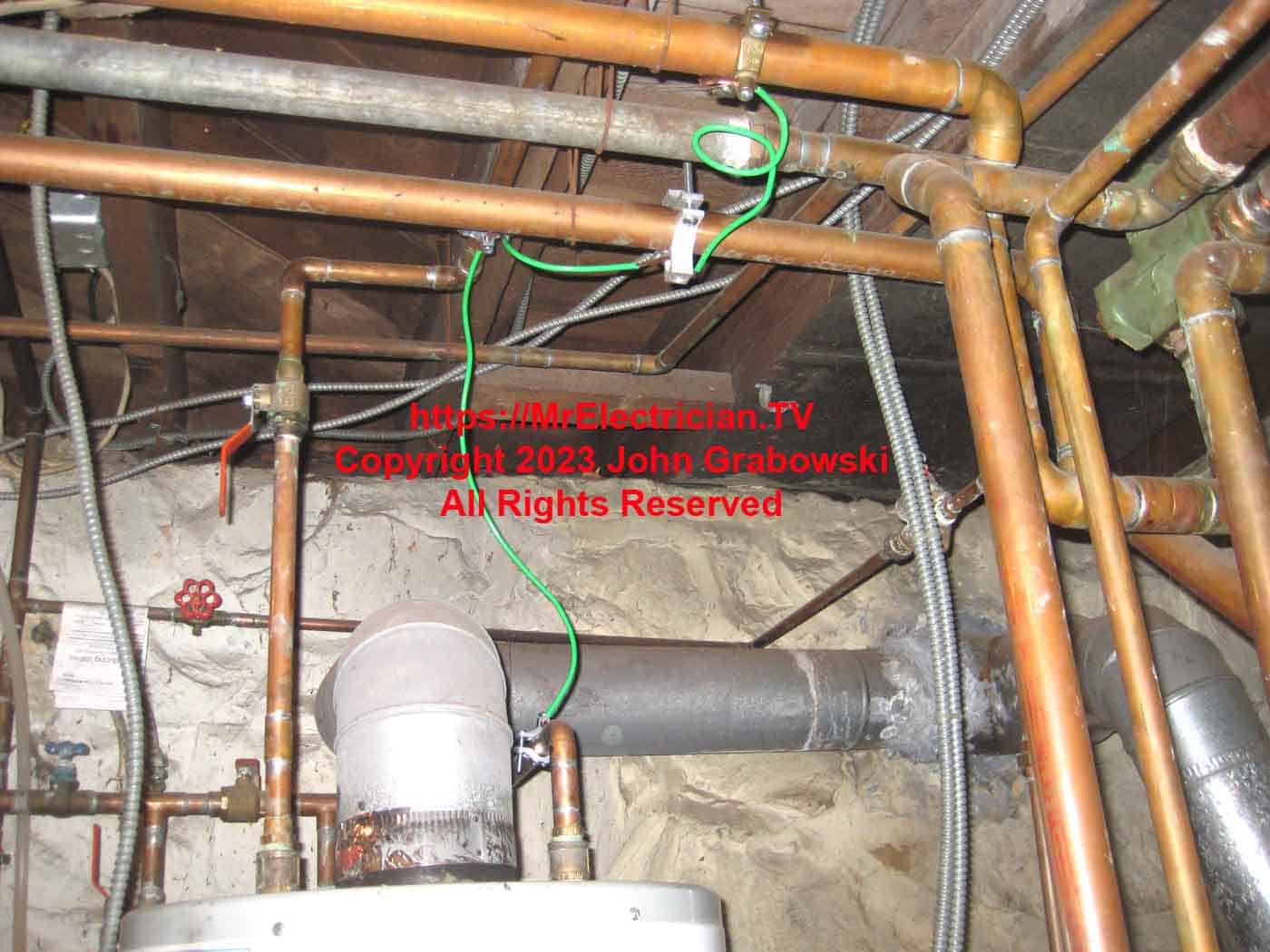 Water pipe bonding of the heating system copper pipes using water pipe ground clamps and number 4 green copper wire