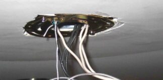 Close-up photo of the electrical wiring connections on a ceiling hung light fixture.