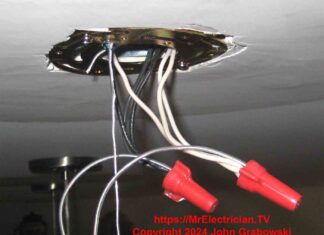 Close-up photo of the electrical wiring connections on a ceiling hung light fixture.