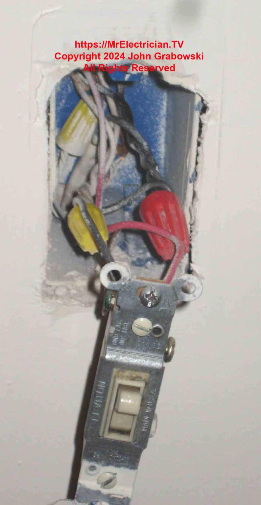 An existing wall switch with the correct wires needed for adding a new outlet.