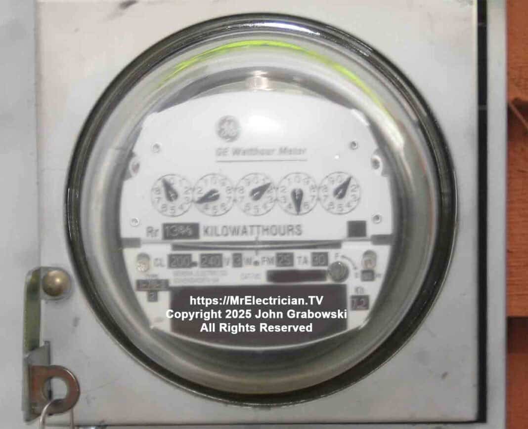 A close shot of an older General Electric watt-hour electric meter that measures electricity consumption using kilowatt-hours