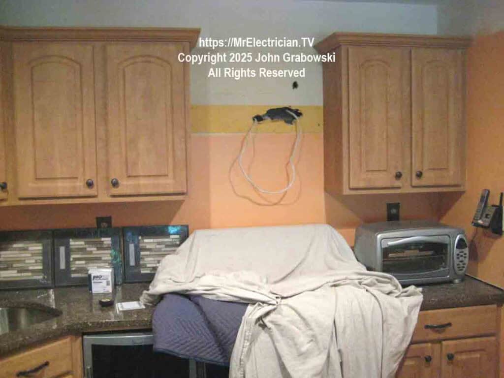 Preparation for the installation of a new kitchen chimney hood between cabinets and over the stove using the existing electrical wiring Preparation for the installation of a new kitchen chimney hood between cabinets and over the stove using the existing electrical wiring