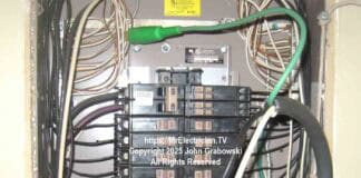 A Cutler-Hammer type CH residential electrical load center with spring clips being used to siphon off electrical power using a portable rubber cord