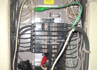 A Cutler-Hammer type CH residential electrical load center with spring clips being used to siphon off electrical power using a portable rubber cord
