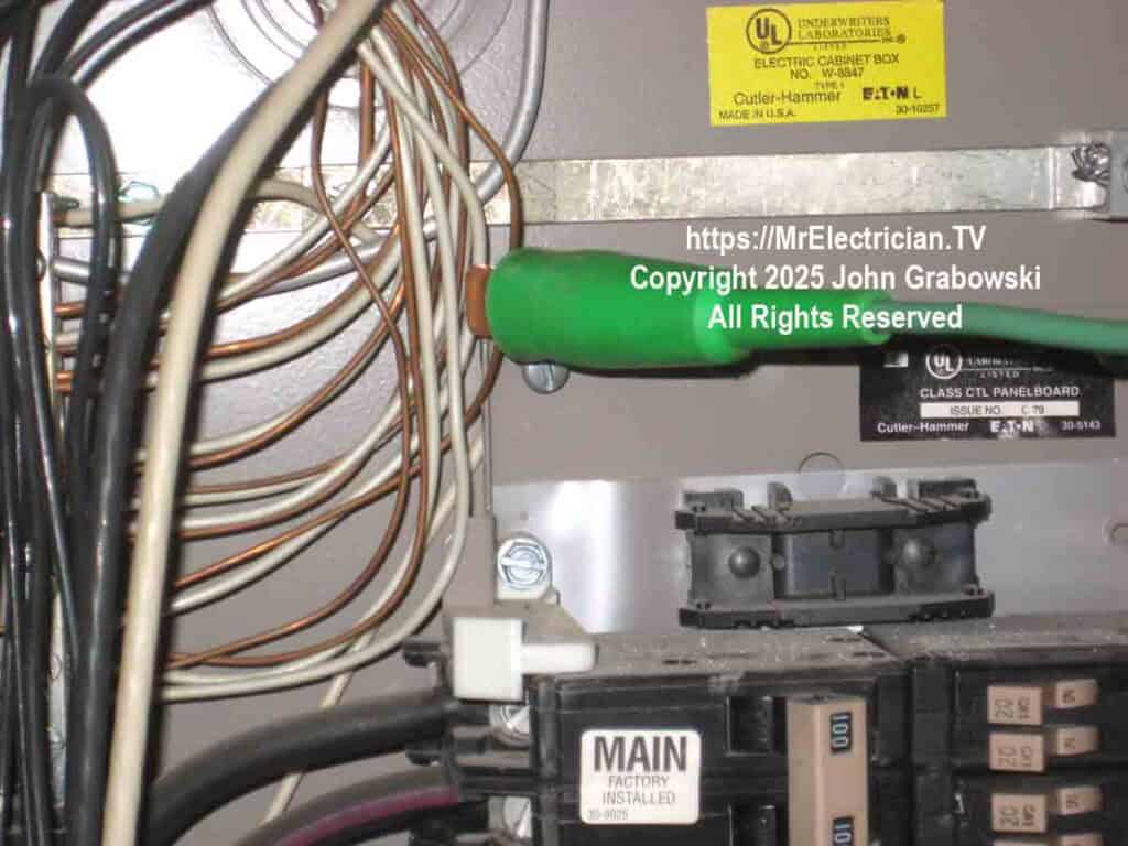 A green insulated wire clip attached to an equipment grounding conductor inside of a Cutler-Hammer type CH residential electrical load center