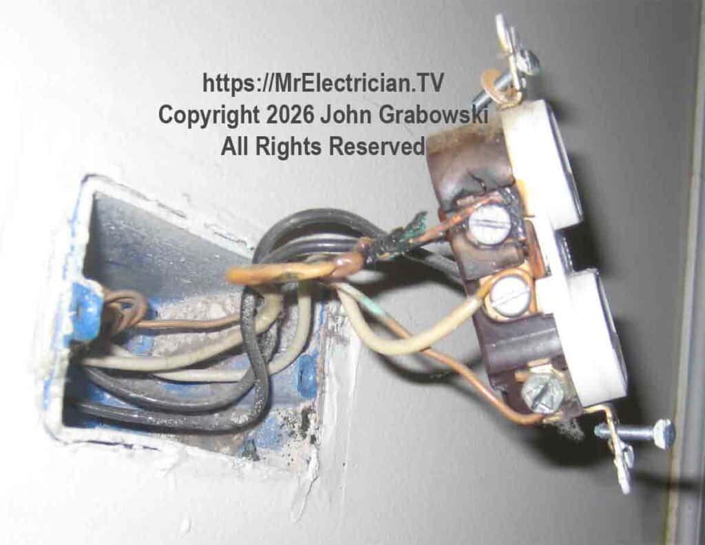An electrical receptacle outlet with a burned white wire as a result of a loose screw connection. If this electrical outlet had been pigtailed, the severity of the arcing might have been smaller