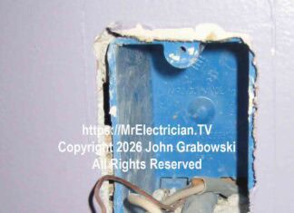 An ivory colored electrical wall switch hanging from a blue plastic switch box by a white wire, a black wire, and a bare copper wire. There is no neutral available here.